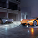 A photo of two Lamborghini Aventadors in a studio.